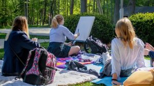 students creating art outdoors